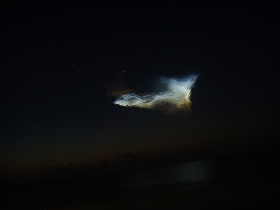 A luminous twilight cloud from a Delta II rocket launch over the Florida coast